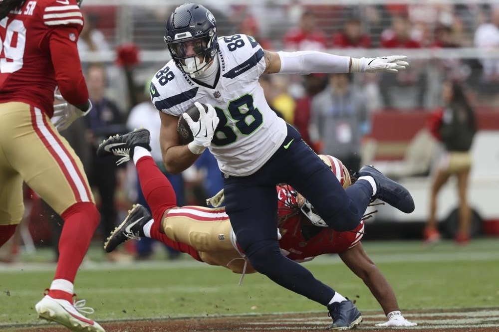 Seattle Seahawks tight end AJ Barner (88) runs against San Francisco 49ers linebacker Fred Warner, bottom, during the second half of an NFL football game in Santa Clara, Calif., Sunday, Nov. 17, 2024. (AP Photo/Jed Jacobsohn)