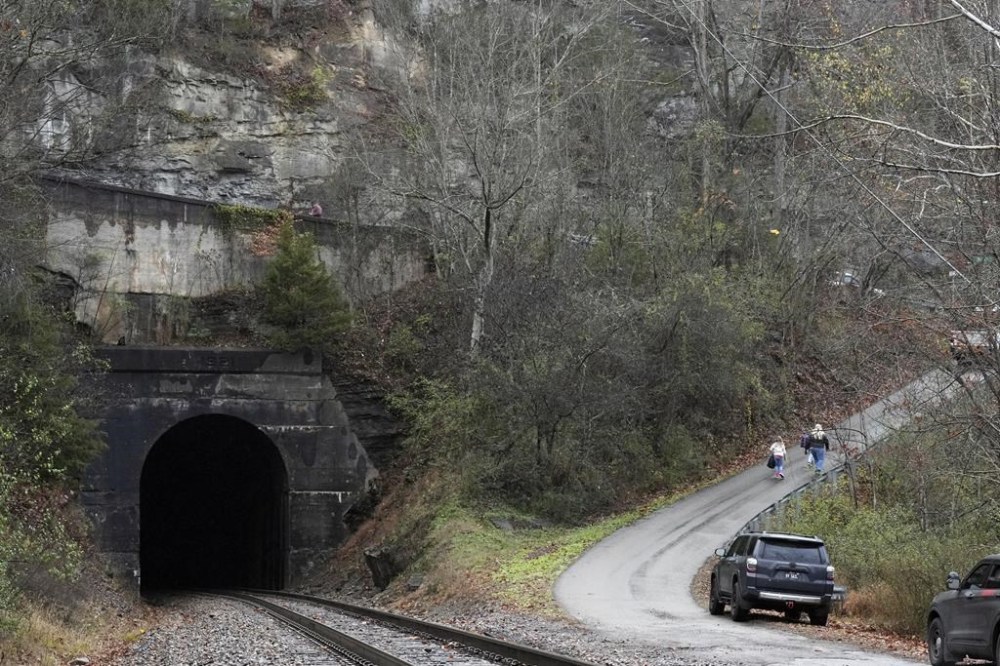 People leave after a visit of the CSX Santa Train, Saturday, Nov. 23, 2024, in Haysi, Va. The train brings presents to small towns along a 110-mile portion of the railroad line in rural Appalachian Tennessee, Kentucky and Virginia. (AP Photo/George Walker IV)
