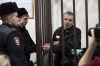 Imprisoned Kremlin critic Alexei Gorinov, 63, right, appears in court as his second trial for criticizing Russia's actions in Ukraine swiftly nears its conclusion stands in a cage in Vladimir, Russia, Friday, Nov. 29, 2024. (AP Photo/Dmitry Serebryakov)