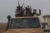 Syrian opposition fighters ride in a truck in Talhiya, Idlib countryside, Syria, Friday, Nov. 29, 2024. (AP Photo/Ghaith Alsayed)