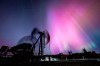 The Northern Lights, aurora borealis, make an appearance over pumpjacks as they draw out oil and gas from well heads near Cremona, Alta., Thursday, Oct. 10, 2024. THE CANADIAN PRESS/Jeff McIntosh