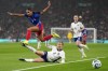 United States' Alyssa Thompson jumps over England's Lucy Bronze during the International friendly women soccer match between England and United States at Wembley stadium in London, Saturday, Nov. 30, 2024. (AP Photo/Kirsty Wigglesworth)