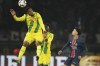 Nantes' Jean-Philippe Gbamin, left, heads the ball during the French League One soccer match between Paris Saint-Germain and Nantes at the Parc des Princes stadium in Paris, France, Saturday, Nov. 30, 2024. (AP Photo/Christophe Ena)