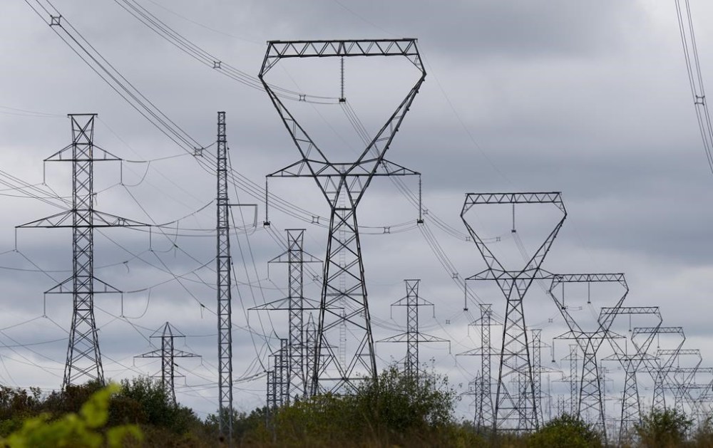 Power lines are seen against cloudy skies near Murvale, Ont., northwest of Kingston, Wednesday, Sept. 7, 2022. THE CANADIAN PRESS/Adrian Wyld