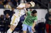 Los Angeles Galaxy defender John Nelson, left, heads the ball over Seattle Sounders midfielder Alex Roldan during the first half an MLS Western Conference final soccer match, Saturday, Nov. 30, 2024, in Carson, Calif. (AP Photo/Etienne Laurent)