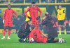Bayern's Harry Kane gets treatment on the pitch after getting injured during the German Bundesliga soccer match between Borussia Dortmund and Bayern Munich at the Signal-Iduna Park in Dortmund, Germany, Saturday, Nov. 30, 2024. (Federico Gambarini/dpa/dpa via AP)