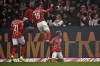 Mainz's Danny da Costa, left and Anthony Caci, in air, celebrate after Mainz's Jonathan Burkhardt scored his side's second goal, during a German Bundesliga soccer match between FSV Mainz 05 and TSG 1899 Hoffenheim, in Mainz, Germany, Sunday, Dec. 1, 2024. (Torsten Silz/dpa via AP)