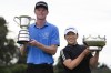 Men's champion, Ryggs Johnston of the United States and women's champion Jiyai Shin of Korea pose with their trophies following the Australian Open golf championship at the Kingston Heath Golf Club in Melbourne, Australia, Sunday, Dec. 1, 2024. (AP Photo/Asanka Brendon Ratnayake)