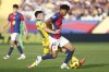 Barcelona's Lamine Yamal, front, and Las Palmas' Alberto Moleiro fight for the ball during a Spanish La Liga soccer match at the Lluis Companys Olympic Stadium in Barcelona, Spain, Saturday Nov. 30, 2024. (AP Photo/Joan Monfort)
