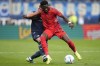 Bochum's Felix Passlack holds Bayern's Alphonso Davies during the German Bundesliga soccer match between VfL Bochum and Bayern Munich in Bochum, Germany, Sunday, Oct. 27, 2024. THE CANADIAN PRESS/AP-Martin Meissner