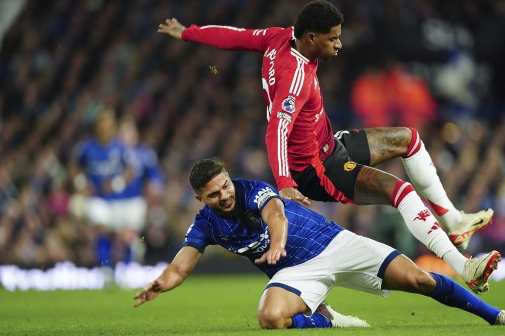 Ipswich Town's Sam Morsy, bottom, tackles Manchester United's Marcus Rashford during the English Premier League soccer match between Ipswich Town and Manchester United at Portman Road stadium in Ipswich, England, Sunday, Nov. 24, 2024. (AP Photo/Dave Shopland)