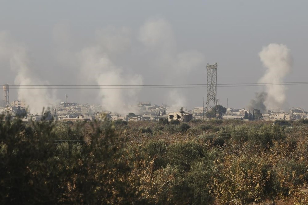 Smoke from fighting billows in the edges of the town of Hama, Syria, Tuesday Dec. 3, 2024.(AP Photo/Ghaith Alsayed)