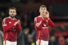 Manchester United's Luke Shaw, left, and Manchester United's Rasmus Hojlund greet fans at the end of the Europa League opening phase soccer match between Manchester United and Bodo Glimt, at the Old Trafford stadium in Manchester, England, Thursday, Nov. 28, 2024. (AP Photo/Dave Thompson)