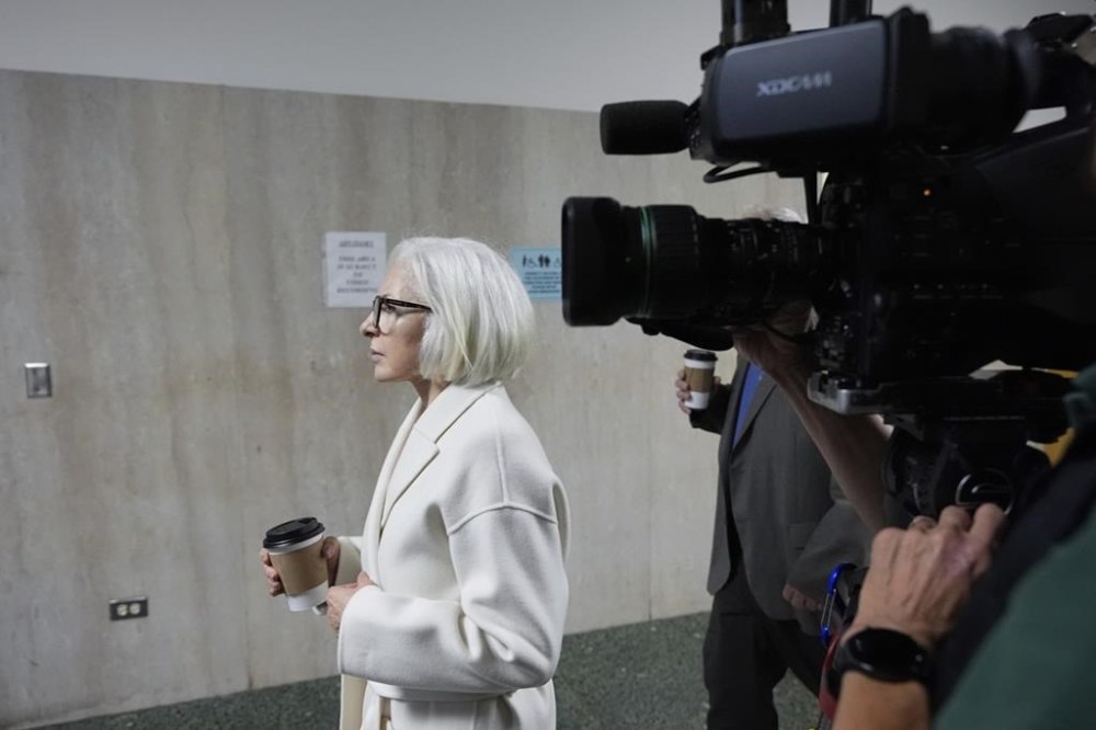 Mahnaz Tayarani, left, mother of Nima Momeni – who is charged with murder in Cash App founder Bob Lee's stabbing death – walks to Department 28 to enter the courtroom at the Hall of Justice for Momeni's murder trial Tuesday, Dec. 3, 2024, in San Francisco. (AP Photo/Godofredo A. Vásquez)