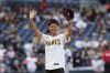 Japanese baseball player Ayami Sato waves to the crowd before throwing out a ceremonial first pitch before the San Diego Padres host the Houston Astros in a baseball game in San Diego, Calif., Monday, Sept. 16, 2024. THE CANADIAN PRESS/AP-Gregory Bull