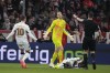 Leverkusen's Jeremie Frimpong, lays on pitch after he was fouled by Bayern's goalkeeper Manuel Neuer, center ,during a German Cup round of 16 soccer match between Bayern Munich and Bayer Leverkusen at the Allianz Arena in Munich, Germany, Monday. Dec.3, 2024. (AP Photo/Matthias Schrader)