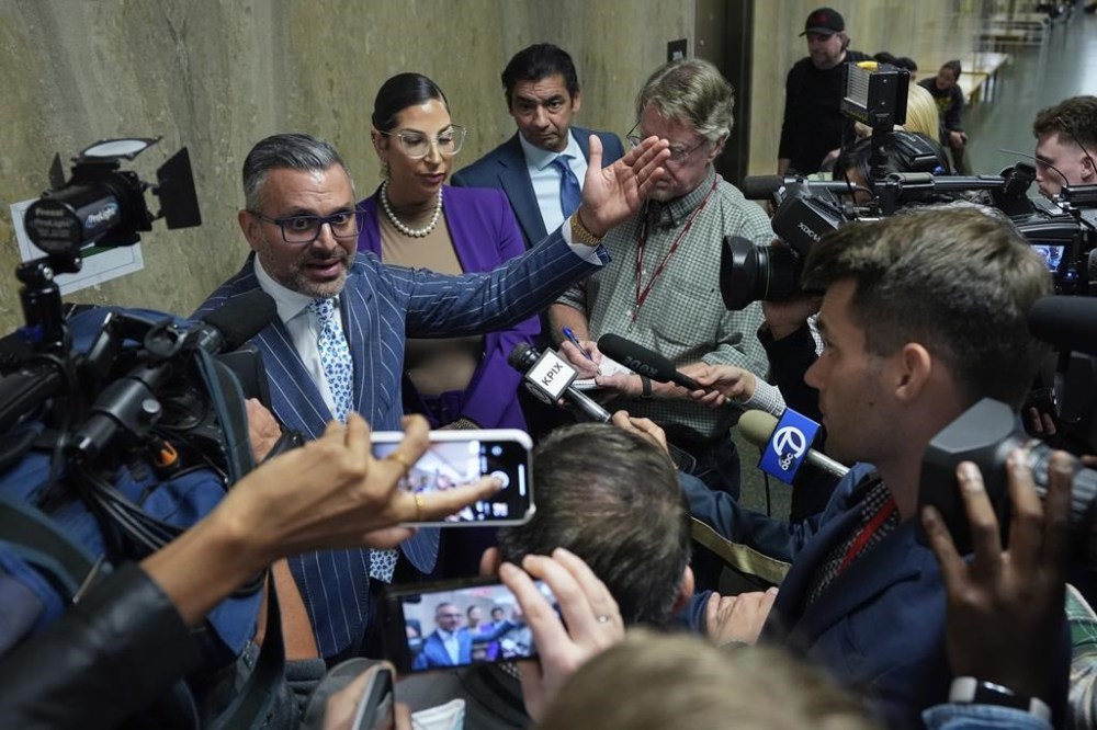 Defense attorney Saam Zangeneh, top left, speaks to reporters after exiting the courtroom at the Hall of Justice for the murder trial of Nima Momeni, Tuesday, Dec. 3, 2024, in San Francisco. (AP Photo/Godofredo A. Vásquez)