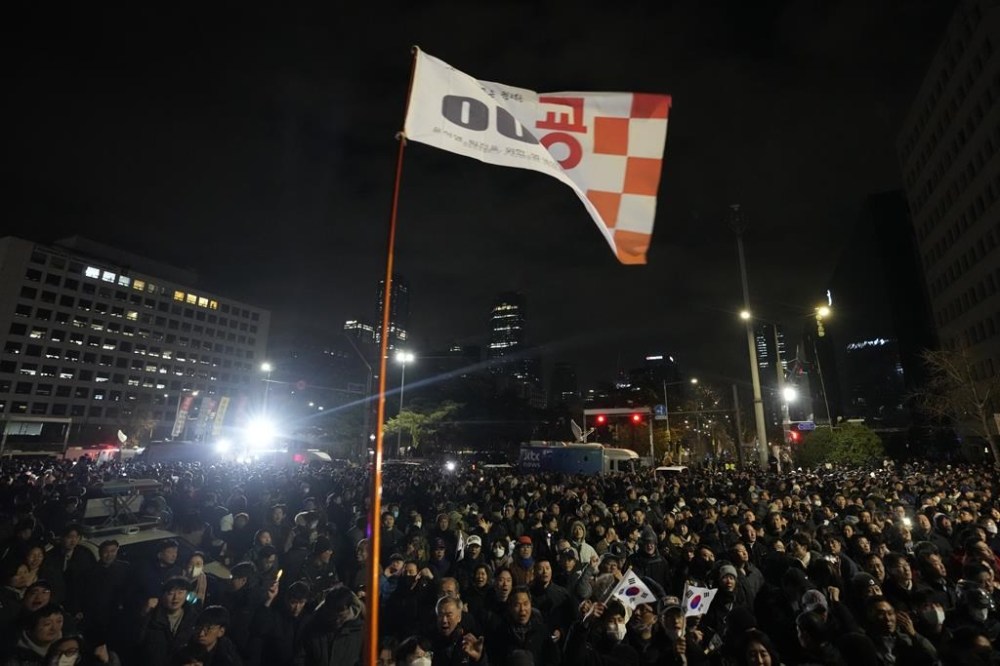 People gather in front of the National Assembly in Seoul, South Korea, Wednesday, Dec. 4, 2024. (AP Photo/Ahn Young-joon)