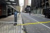 A New York police officer walks outside a hotel where a shooting occurred in midtown Manhattan, Wednesday, Dec. 4, 2024, in New York. (AP Photo/Joe Frederick)