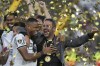 Coach Artur Jorge of Brazil's Botafogo, right, and Junior Santos celebrate after winning the Copa Libertadores final soccer match against Brazil's Atletico Mineiro at Monumental stadium in Buenos Aires, Argentina, Saturday, Nov. 30, 2024. (AP Photo/Gustavo Garello)