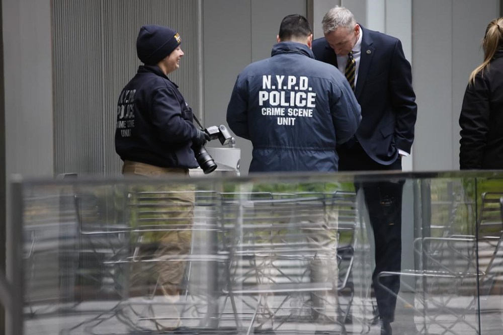 Members of the New York police crime scene unit investigate the scene outside the Hilton Hotel in midtown Manhattan where Brian Thompson, the CEO of UnitedHealthcare, was fatally shot Wednesday, Wednesday, Dec. 4, 2024, in New York. (AP Photo/Stefan Jeremiah)