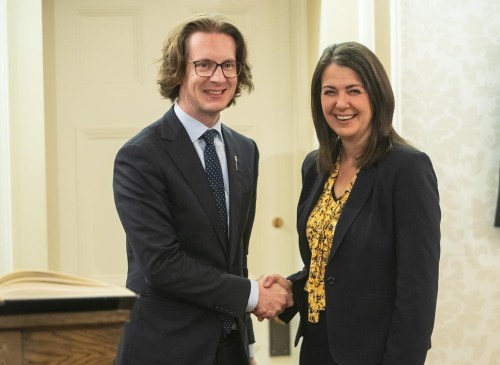 Nate Glubish shakes hands with Alberta Premier Danielle Smith after Glubish was sworn into cabinet as Minister of Technology and Innovations in Edmonton, Monday, Oct. 24, 2022. Glubish says he's hoping to see $100 billion worth of artificial intelligence data centres under construction within the next five years.THE CANADIAN PRESS/Jason Franson