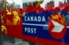Canada Post employees and supporters rally as they are reflected in a window at Canada Post headquarters in Ottawa, Thursday, Nov. 28, 2024. THE CANADIAN PRESS/Sean Kilpatrick