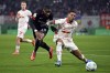 Leipzig's Benjamin Henrichs, right, and Frankfurt's Niels Nkounkou battle for the ball during a German Cup match between RB Leipzig and Eintracht Frankfurt at the Red Bull Arena, in Leipzig, Germany, Wednesday, Dec. 4, 2024. (Hendrik Schmidt/dpa via AP)