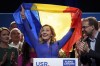 Elena Lasconi, the Save Romania Union (USR) party candidate in the country's presidential elections, holds Romania's flag at the end of a meeting with supporters after making it to the Dec. 8, runoff in Bucharest, Romania, Monday, Nov. 25, 2024. (AP Photo/Andreea Alexandru)