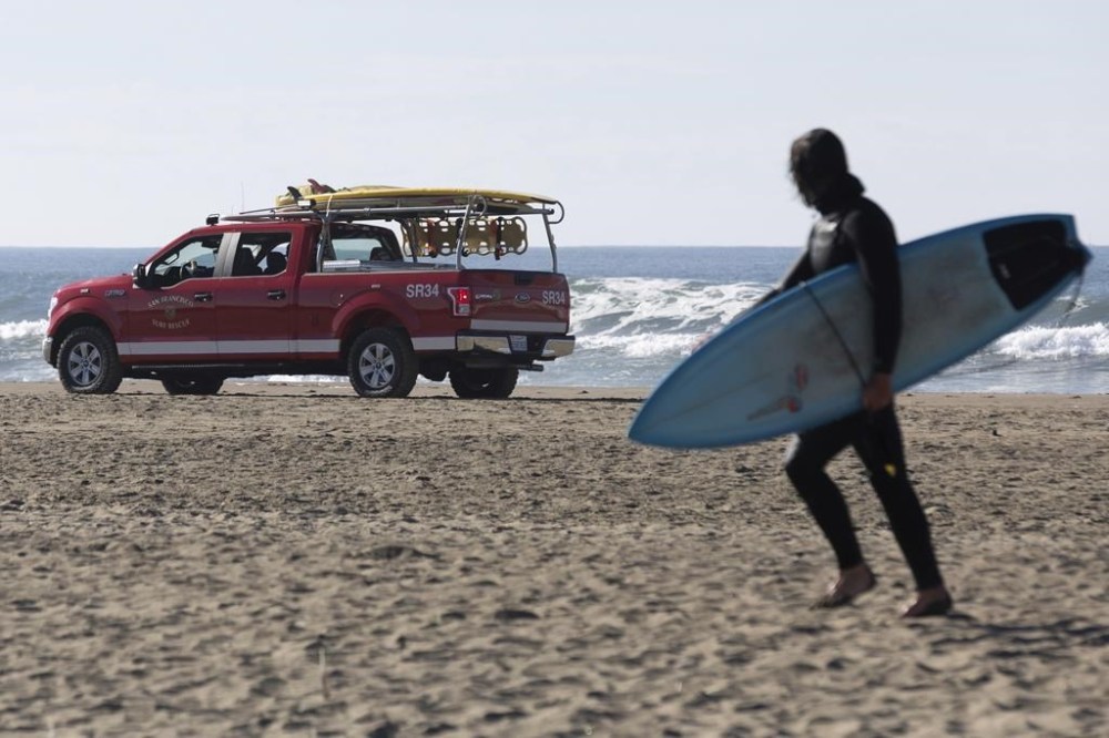 A San Francisco Surf Rescue team evacuates surfers from Ocean Beach in case of a possible tsunami on Thursday, Dec. 5, 2024. San Francisco residents were notified of a chance of a tsunami following a reported earthquake in Northern California. (Benjamin Fanjoy/San Francisco Chronicle via AP)