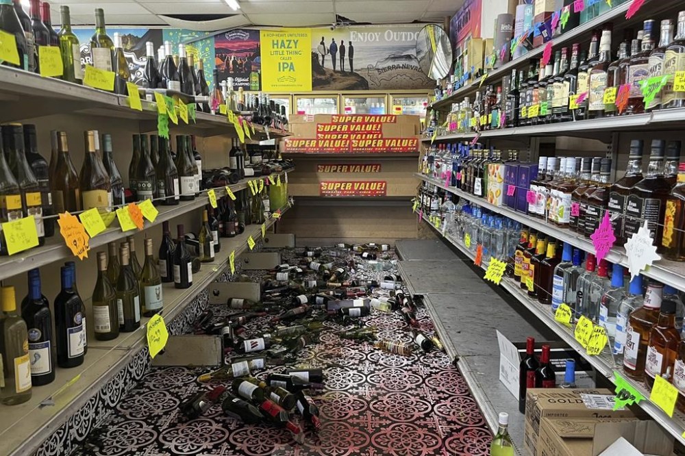 Broken bottles are scattered on the floor inside E&J Liquors after a 7.0 magnitude earthquake, Thursday, Dec. 5, 2024, in Rio Dell, Calif. (Savana Robinson via AP )