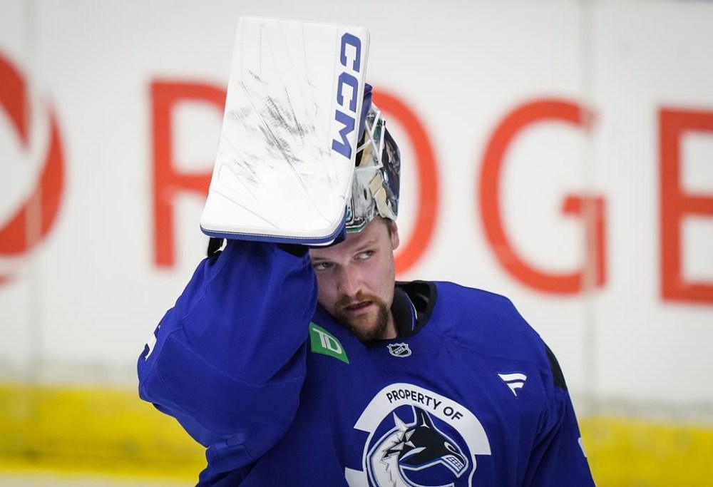 Vancouver Canucks goalie Thatcher Demko lifts his mask off his face while practicing with coaches during the opening day of the NHL hockey team's training camp, in Penticton, B.C., on Thursday, September 19, 2024. THE CANADIAN PRESS/Darryl Dyck