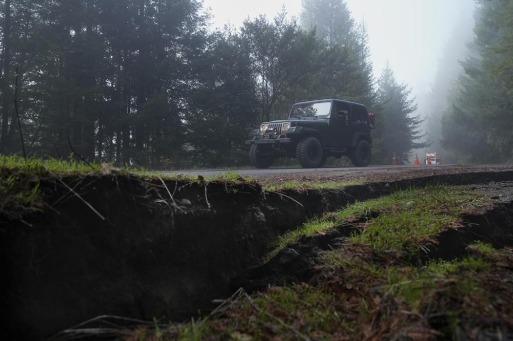 A motorist drives along a road damaged by a 7.0 earthquake Friday, Dec. 6, 2024, in Humboldt County, Calif. (AP Photo/Godofredo A. Vásquez)