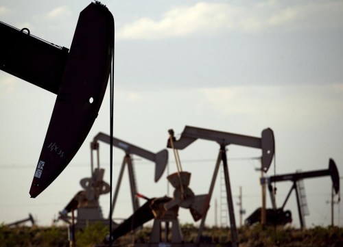 FILE - Pump jacks work in a field near Lovington, N.M., April 24, 2015. (AP Photo/Charlie Riedel, File)