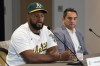 Right-hander Luis Severino, left, talks to reporters during a news conference in Sacramento, Calif., Friday, Dec. 6, 2024, about his decision to sign a contract with the Oakland Athletics as his agent Nelson Montes De Oca, right, looks on. (AP Photo/Rich Pedroncelli)