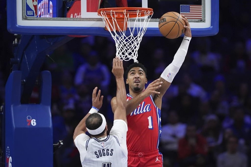 Philadelphia 76ers' KJ Martin, right, goes up for a dunk against Orlando Magic's Jalen Suggs during the first half of an NBA basketball game, Friday, Dec. 6, 2024, in Philadelphia. (AP Photo/Matt Slocum)