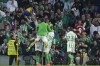 Real Betis players celebrate after Betis' Assane Diao scored his side's second goal during a Spanish La Liga soccer match between Betis and Barcelona at the Benito Villamarin stadium in Seville, Spain, Saturday, Dec. 7, 2024. (AP Photo/Jose Breton)
