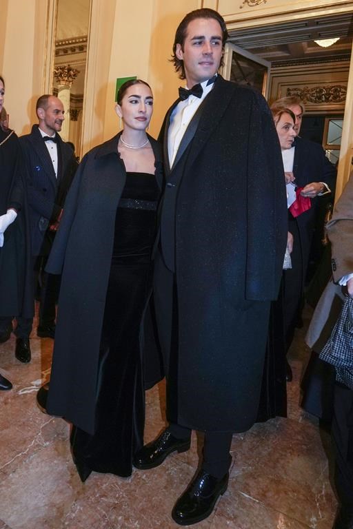 Olympic medallist Gianmarco Tamberi and wife Chiara Bontempi, left, pose for photographers as they arrive at Milan's Opera House La Scala, northern Italy, for the opening of the 2024-25 season featuring Giuseppe Verdi's 'La Forza del destino', Saturday, Dec. 7, 2024. (AP Photo/Luca Bruno)