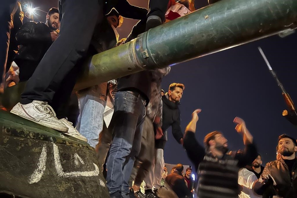 Syrians celebrate the arrival of opposition fighters in Damascus, Syria, Sunday Dec. 8, 2024. (AP Photo/Omar Sanadiki)