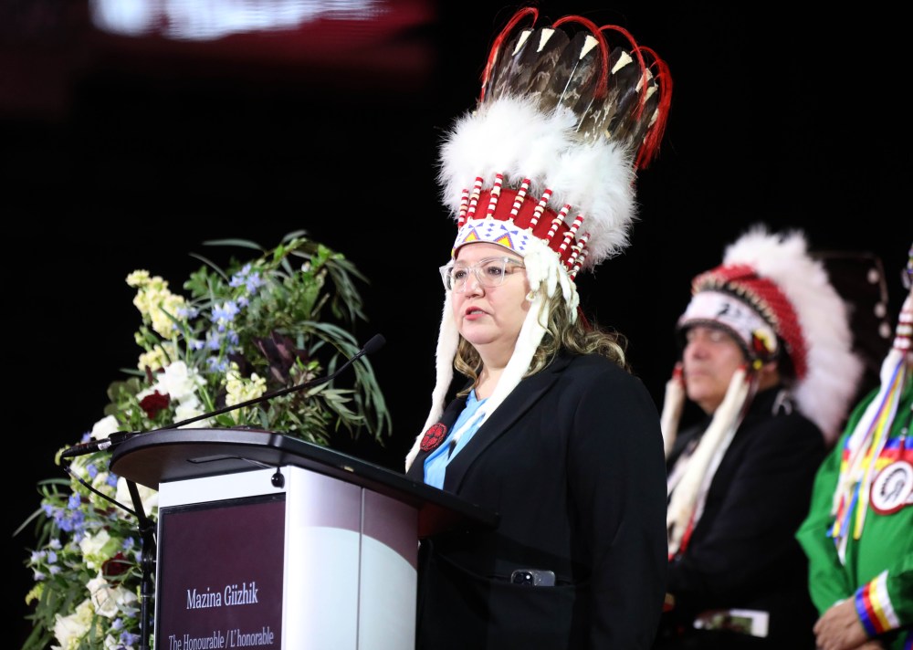 National Chief Cindy Woodhouse gives her remarks, along with other chiefs who came from across the country, and stood with her at the service. (Ruth Bonneville / Free Press)