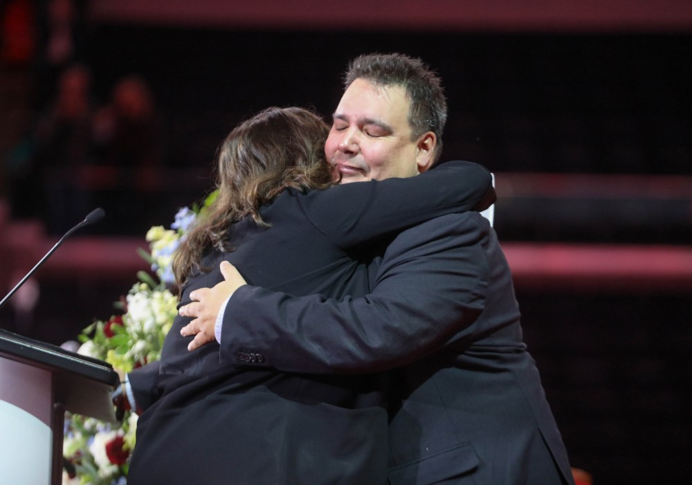 Niigaan Sinclair and his daughter, Sarah Fontaine Sinclair, embrace after speaking proudly of her grandfather during the service. (Ruth Bonneville / Free Press)