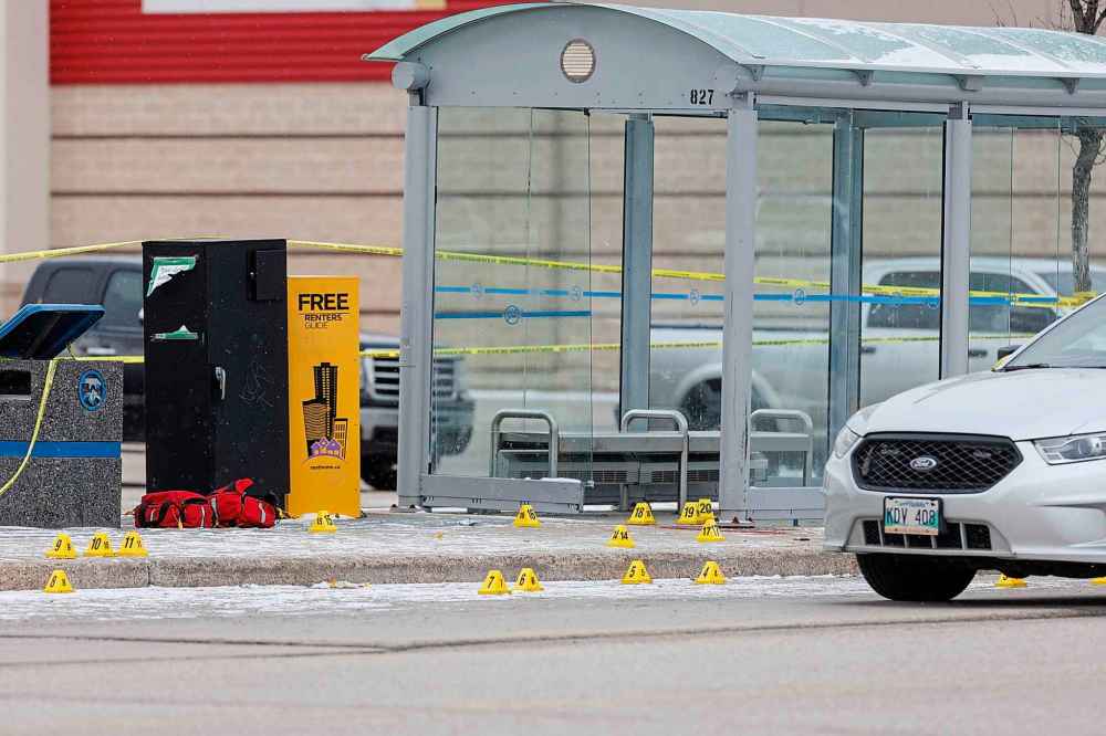 Winnipeg police shot and killed a male outside a bus shelter at a west Winnipeg shopping area Sunday after they say he stabbed an officer in the throat. (Mike Deal / Free Press)