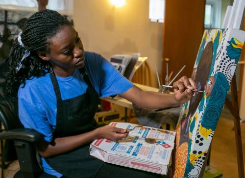BROOK JONES / FREE PRESS
                                Multidisciplinary artist Efe Ogboru, who is in her final year of a fine arts degree at the University of Manitoba, does some work on an untitled painting in her home studio in Winnipeg recently.