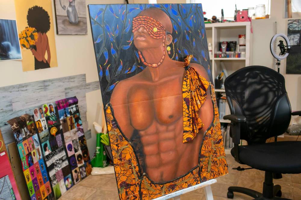 BROOK JONES / FREE PRESS
An oil painting by Ogboru is titled Ejomafuvwe. Ogboru often adds texture and depth to her works by utilizing elements such as beads, glitter, stones and synthetic hair.