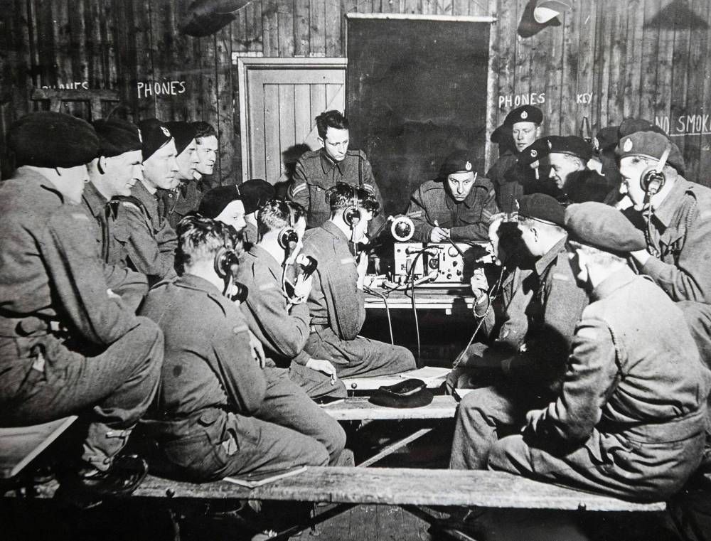 SUPPLIED
Bob Ellerbeck (centre) was a wireless radio operator who had worked inside a tank to keep in contact with other tank units and their commander.
