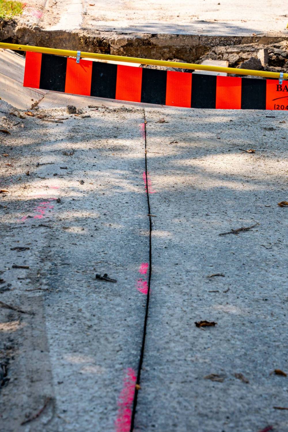 NIC ADAM / FREE PRESS
                                After a long wait, pothole repairs finally commence along Augusta Drive on Aug. 19.