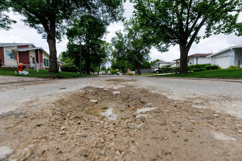 MIKE DEAL / FREE PRESS
                                The road conditions in June along the stretch of Augusta Drive between Lakeside and Chancellor drives show potholes, crumbling curbs and cracks in the pavement.