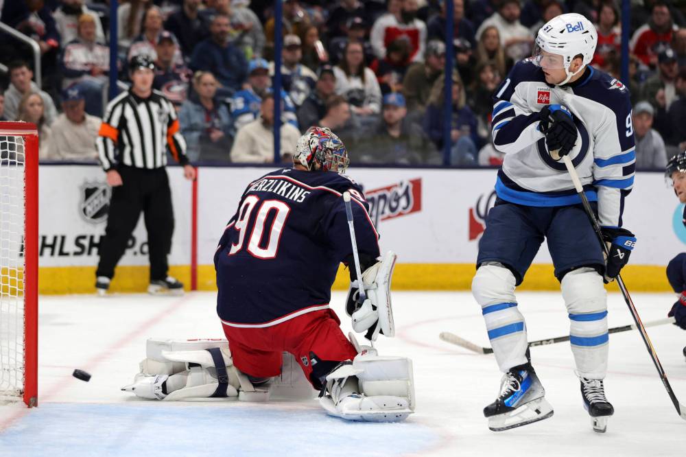 PAUL VERNON / THE ASSOCIATED PRESS
Winnipeg Jets forward Cole Perfetti, right, watches a goal by teammate forward Nikolaj Ehlers past Columbus Blue Jackets goalie Elvis Merzlikins during the first period of an NHL hockey game in Columbus, Ohio, Friday.