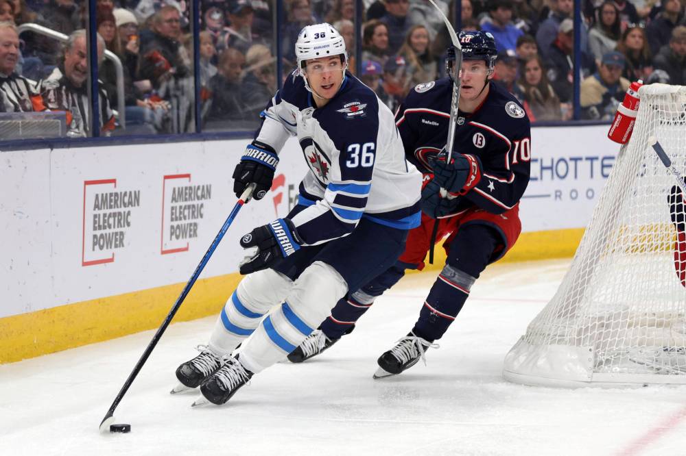 PAUL VERNON / THE ASSOCIATED PRESS
Winnipeg Jets forward Morgan Barron, left, controls the puck in front of Columbus Blue Jackets forward Dmitri Voronkov during the first period of an NHL hockey game in Columbus, Ohio, Friday.