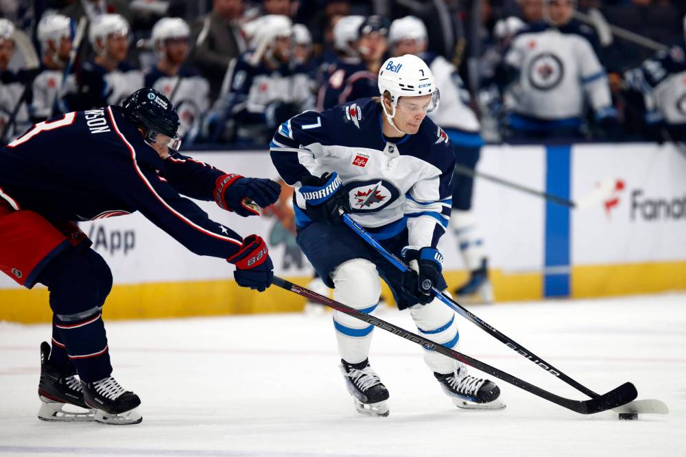 PAUL VERNON / THE ASSOCIATED PRESS
Winnipeg Jets forward Vladislav Namestnikov, right reaches for the puck in front of Columbus Blue Jackets defenseman Jack Johnson during the first period of an NHL hockey game in Columbus, Ohio, Friday.